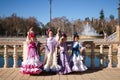 four beautiful little girls dancing flamenco dressed in typical gypsy costume in a famous square in seville, spain. Flamenco,