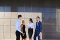 Four beautiful young people, two women and two men talk, chatter