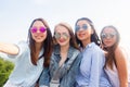 Four beautiful young student girl in colorful sunglasses smiling and taking selfies Royalty Free Stock Photo