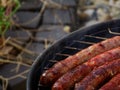 Four beef chipolata sausages on the BBQ Royalty Free Stock Photo