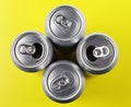 Four Beer Cans on yellow background Royalty Free Stock Photo