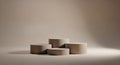 Four beige cylindrical podiums arranged on a light brown surface display stage Royalty Free Stock Photo