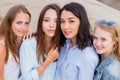 Four best girlfriends looking at camera together. people, lifestyle, friendship, vocation concept Royalty Free Stock Photo