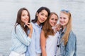 Four best girlfriends looking at camera together. people, lifestyle, friendship, vocation concept. Young cheerful student girl Royalty Free Stock Photo