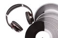Four big black vinyl records beside elegant headphones. Royalty Free Stock Photo