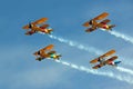 Four Biplanes Flying in Formation with Smoke Royalty Free Stock Photo