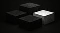 Four black cubes with varying textures and sizes are arranged in a square formation against a black background. Royalty Free Stock Photo