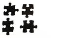 Four black hand-painted piece of a jigsaw puzzle on white background