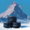 Four black tires against a winter mountain backdrop scene