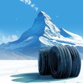 Four black tires against a winter mountain backdrop scene