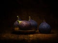 Four black Turkish figs with gold plate. Dark still life.