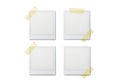 Four blank white paper notes attached with light green tape four square grid arrangement Royalty Free Stock Photo