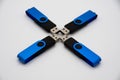 Four blue black USB sticks in a formation on a white background Royalty Free Stock Photo