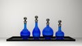 Four blue bottles of different shapes