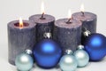 Four blue candles and blue christmas tree balls Royalty Free Stock Photo