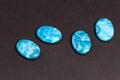 Four blue flat buttons used to create jewelry