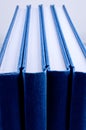 Four blue notepads isolated close up