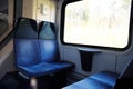 Four blue seats facing each other in modern European train