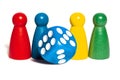 Four board game pieces and blue dice over a plain Royalty Free Stock Photo