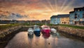Four boats at beautiful dramatic sunset in the marina at Galway City, Ireland