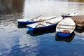 Four boats on the river. Blue old boats at the pier.