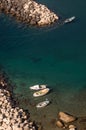 Four boats in a rocky shore