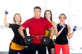 Four bodybuilders standing with dumbbells in gym Royalty Free Stock Photo