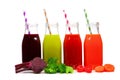 Four bottles of beet, greens, tomato, and carrot juice with ingredients, isolated