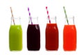 Four bottles of vegetable juice, greens, beet, tomato, and carrot, isolated