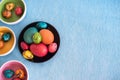 Four bowls with colorful Easter eggs on blue background Royalty Free Stock Photo