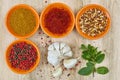 Four bowls with saffron, pepper, ras en hanout, fresh mint and Royalty Free Stock Photo