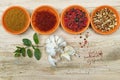 Four bowls with saffron, pepper, ras en hanout, fresh mint and Royalty Free Stock Photo