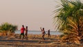 Four boys dancing on the beach at Lake Turkana