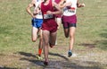 Four boys running 5K race downhill close together Royalty Free Stock Photo