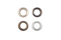 Four brass multicoloured metal eyelets or rivets - curtains rings for fastening fabric to the cornice, isolated on white