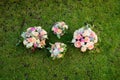 Four bridal bouquets on the green grass.