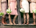 Bridesmaids in cowboy boots on a rustic porch Royalty Free Stock Photo