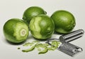 Four bright green limes are displayed on a plain background, with their glossy Royalty Free Stock Photo