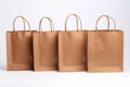 Four brown craft shopping bags. Empty mockup on a white background. Generative AI