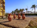 Four brown large clay amphorae stands in the middle of a street in Sharm El Sheikh.