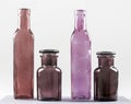 Four brown and violet bottles and their glass transparency
