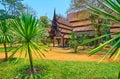 Four Buddha Pavilion behind lush yucca plants, Baan Dam Black House, on May 11 in Chiang Rai, Thailand