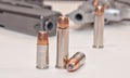 Two sets of different bullets with a revolver and a pistol in the background Royalty Free Stock Photo