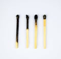 Four burned matches arranged in a row showing the stages of a match burnt Royalty Free Stock Photo