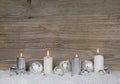 Four burning advent candles on brown wooden background for chris