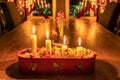 Four burning Advent candles in red candlestick on oak table. Christmas Eve. Traditional decoration in Swedish house with window Royalty Free Stock Photo