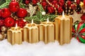 Four burning candles red ornaments Christmas advent decoration Royalty Free Stock Photo