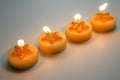 Four burning decorative candles with star pattern