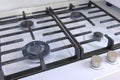 Four burning gas burners from a kitchen gas stove. Gas stove with lattice.