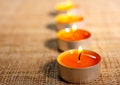 Four burning orange candles Royalty Free Stock Photo